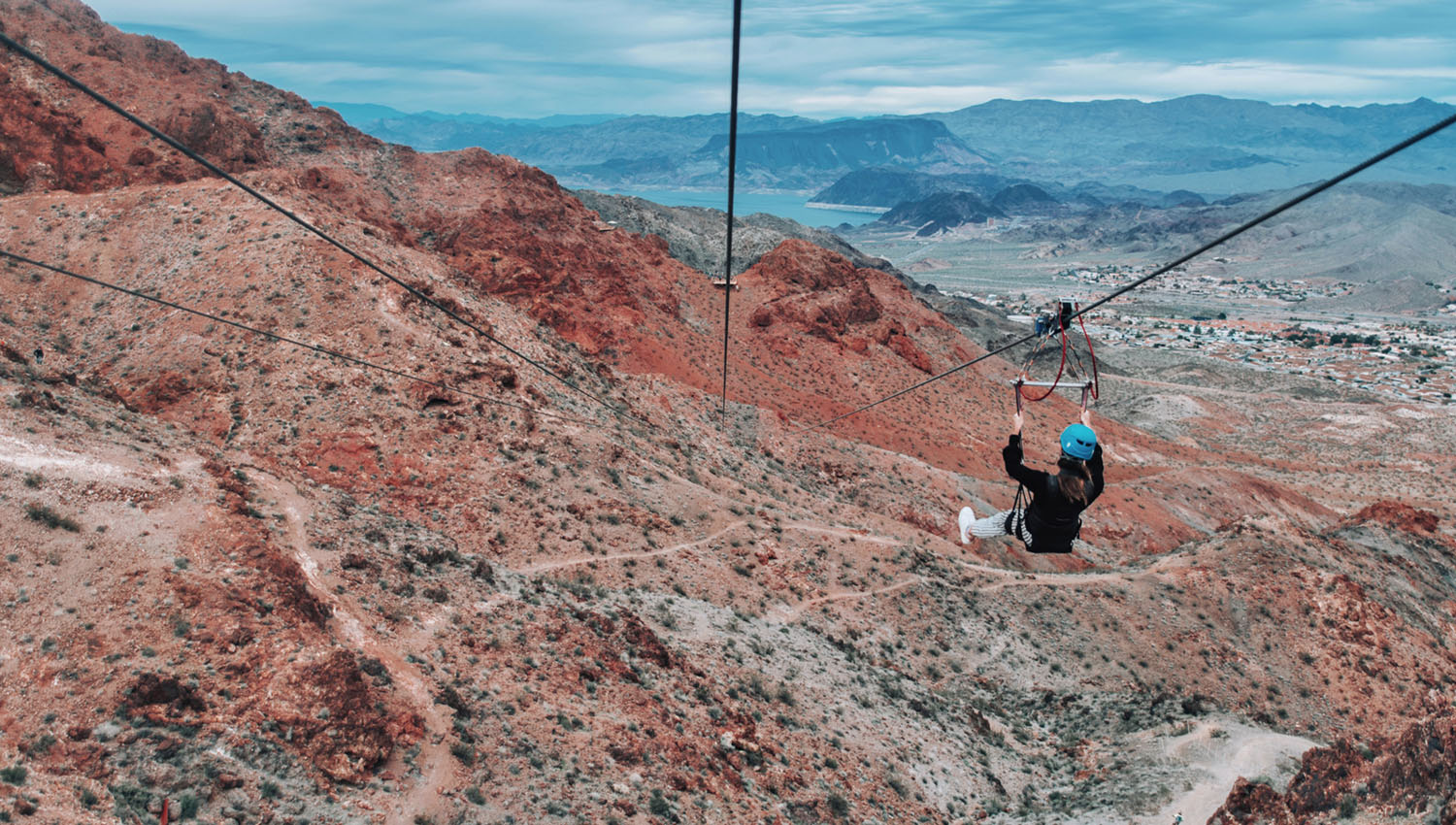 Photo of woman ziplining over the Mojave Desert with Flightlinez