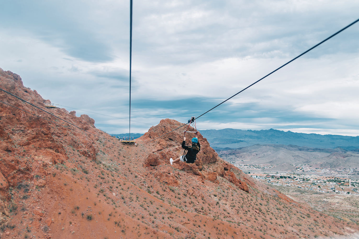 Photo of woman ziplining over the Mojave Desert with Flightlinez