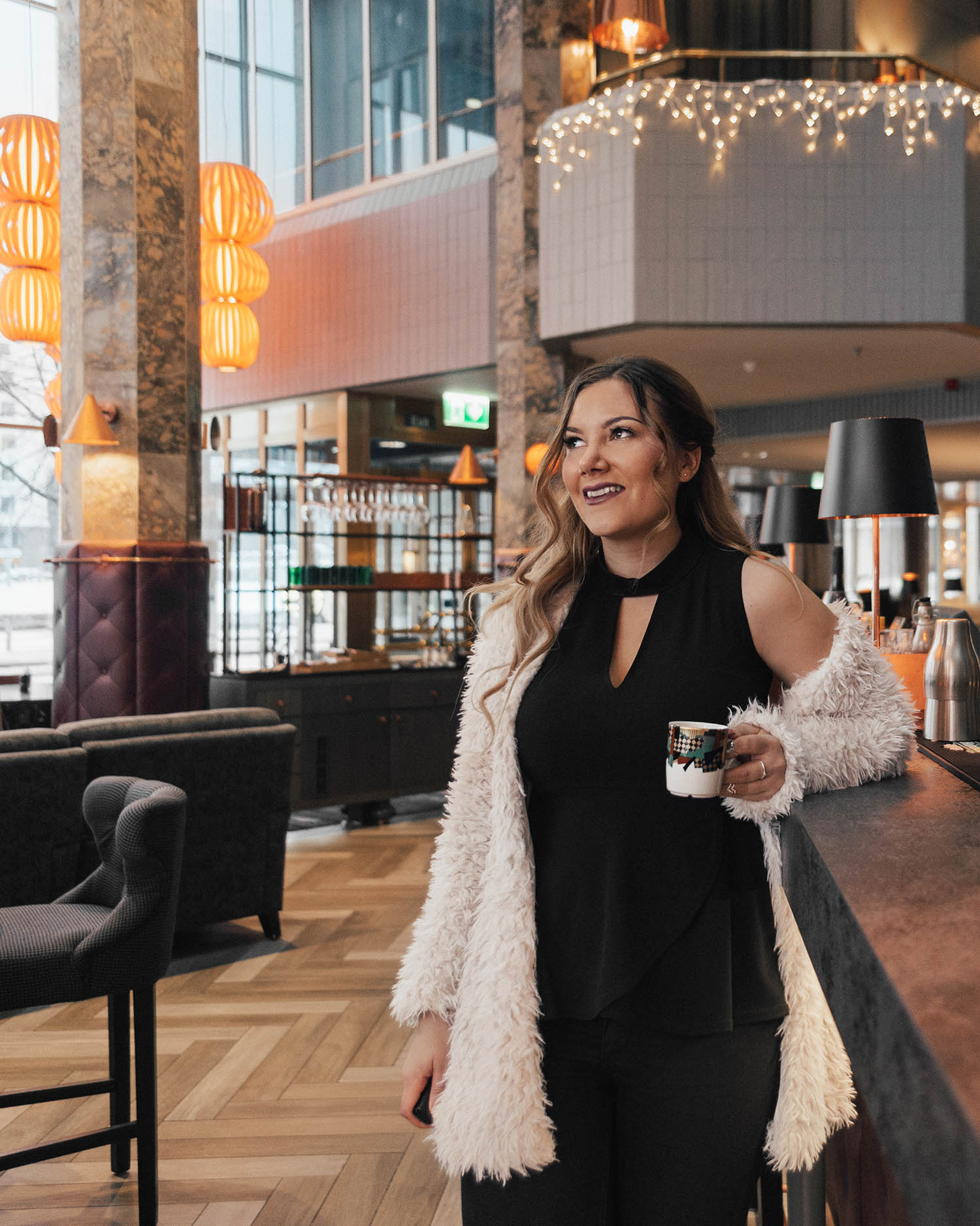 Adaras Outfit: Sexy Black Peplum Top & Fluffy White Cardigan at Hilton Helsinki Strand