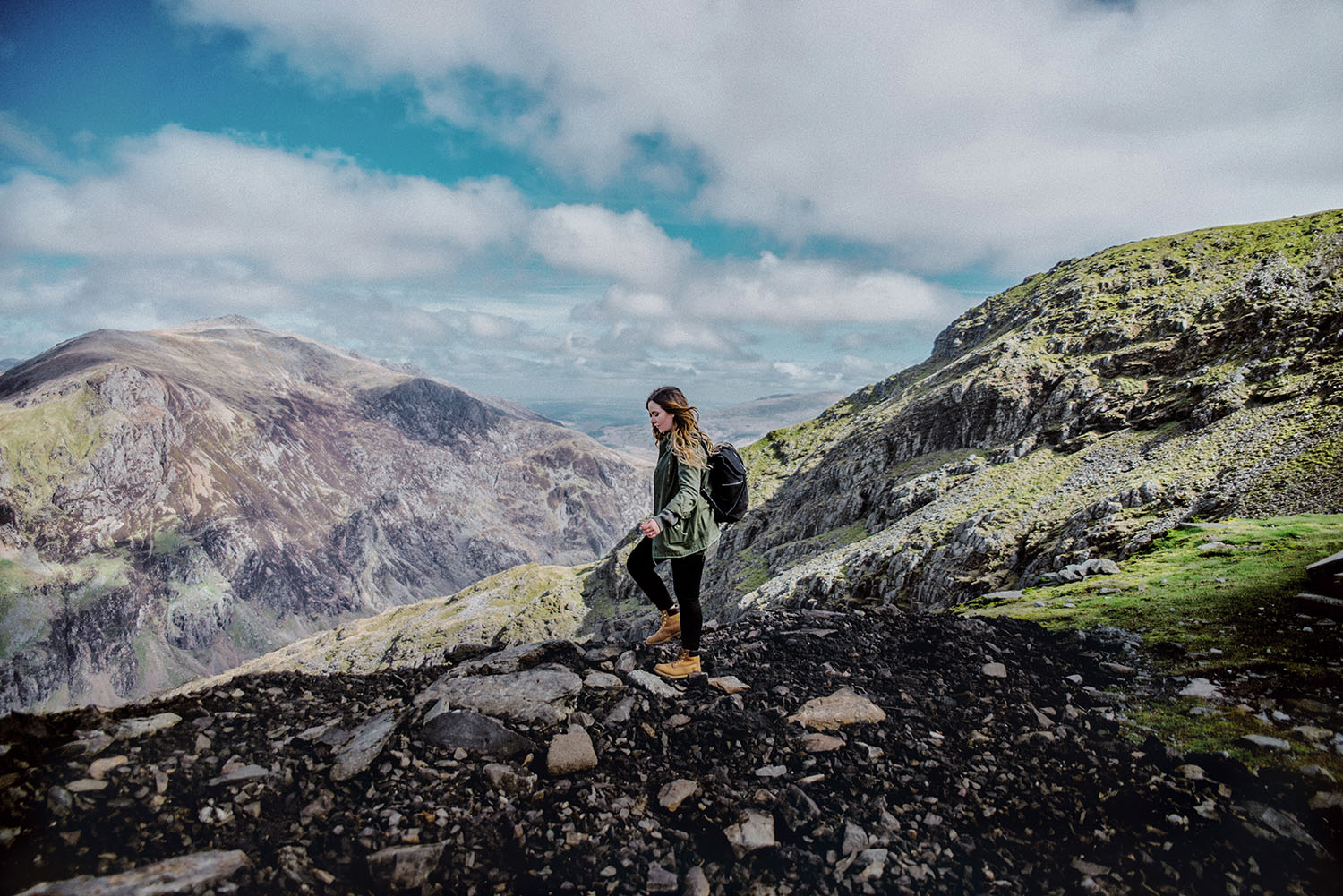 Girl with backpack walking in Clogwyn, Snowdonia National Park in Wales - The Best Place to Visit in The UK