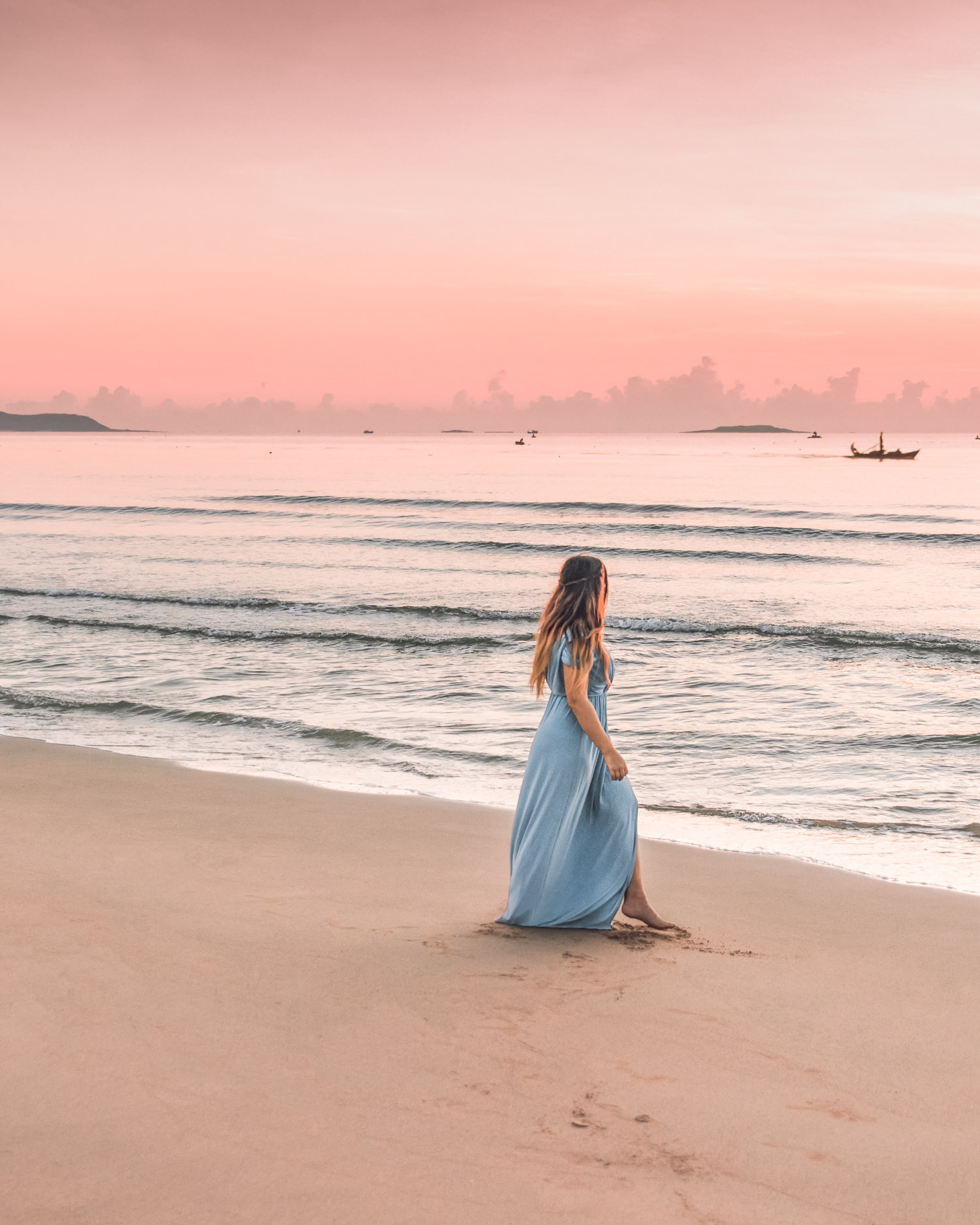 Adaras walking on beach in pink sunrise in Phu Yen, Vietnam