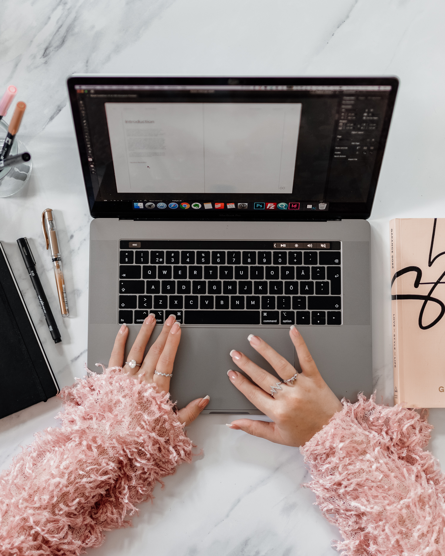 Woman working on a Macbook Pro laptop