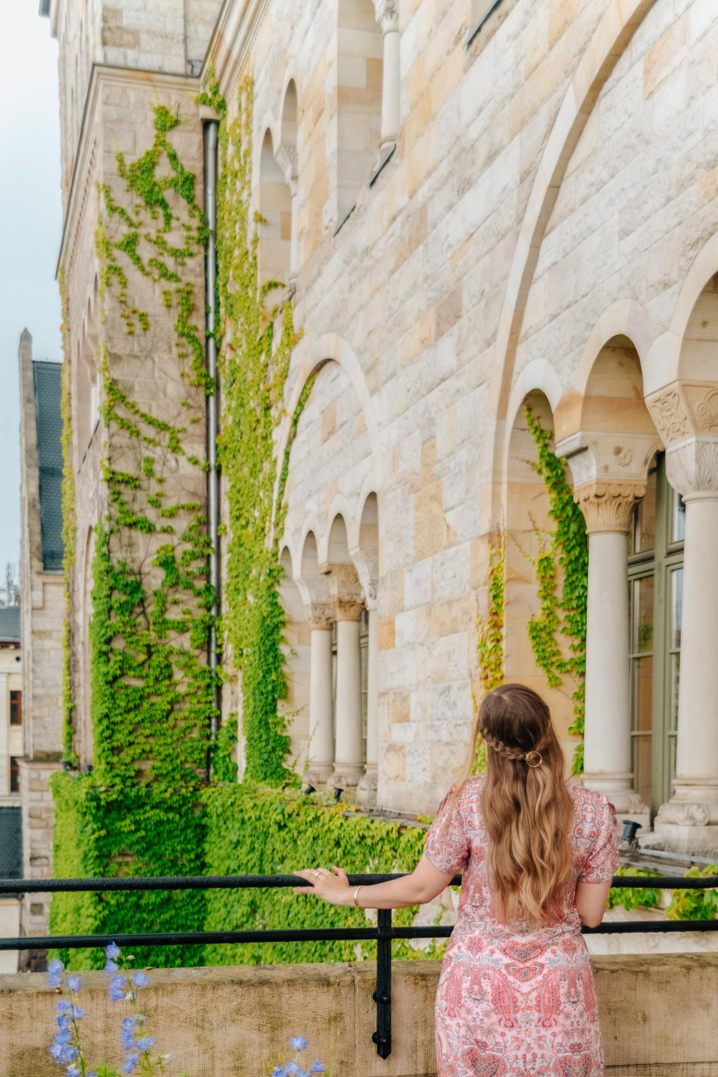 Woman looking out over Imperial Castle (Zamek) in Poznań.