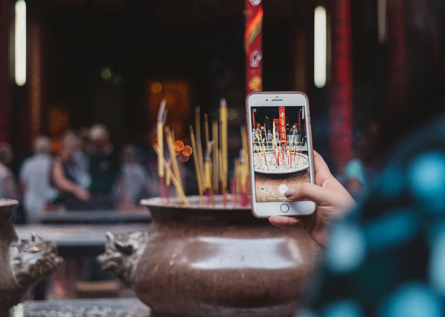 Photo of iPhone taking photo of incense burning at Ong Bon Pagaoda